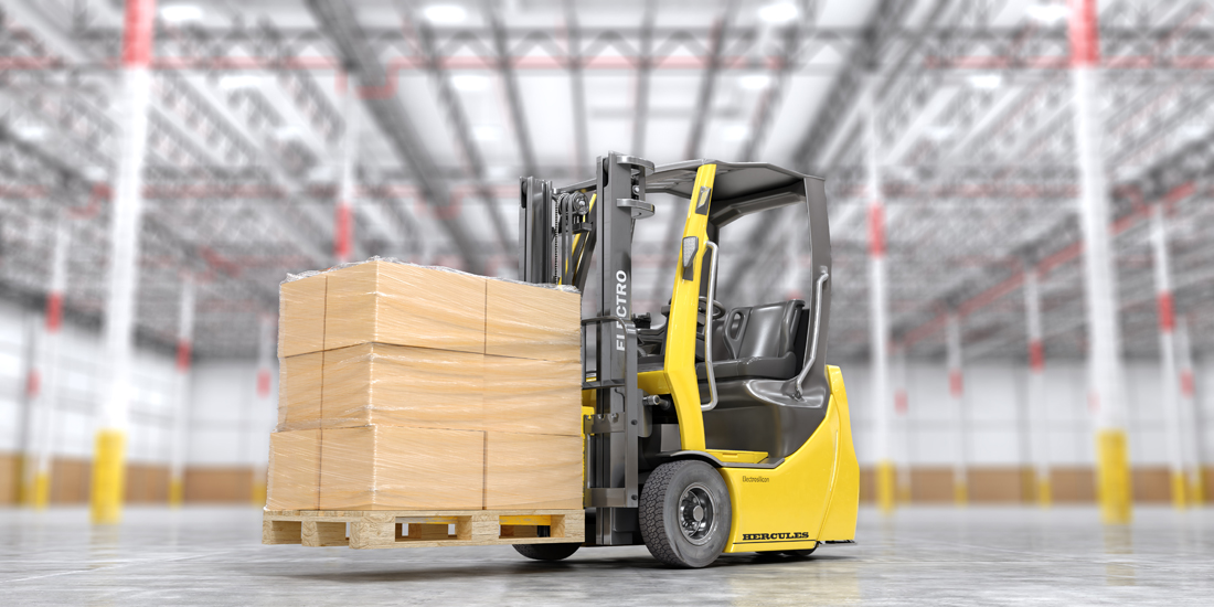 Modern forklift with cardboard boxes on a blurred warehouse back