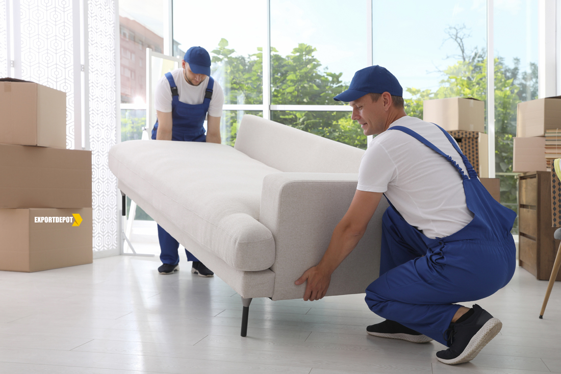 Moving service employees carrying sofa